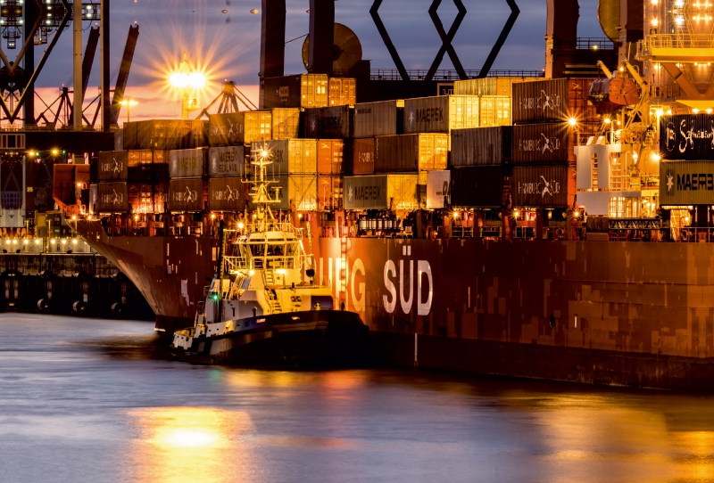 Containerschiff Hamburg Süd mit Schlepper