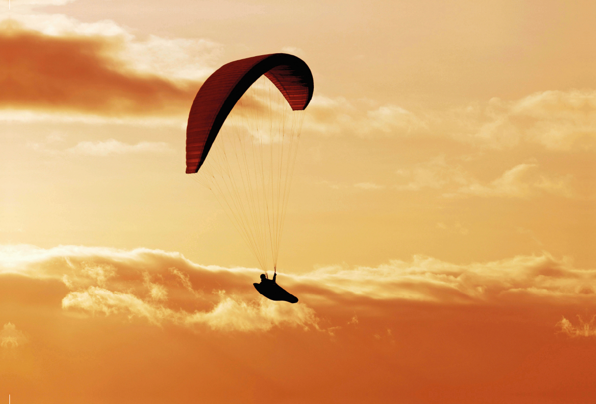 Paragliding im warmen Licht der untergehenden Sonne.