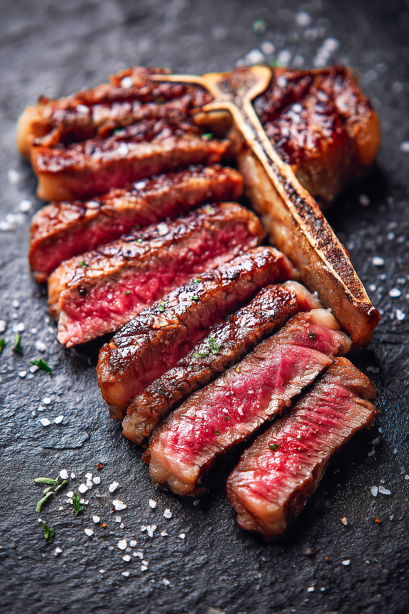 Saftiges T-Bone-Steak in Scheiben mit grobem Salz